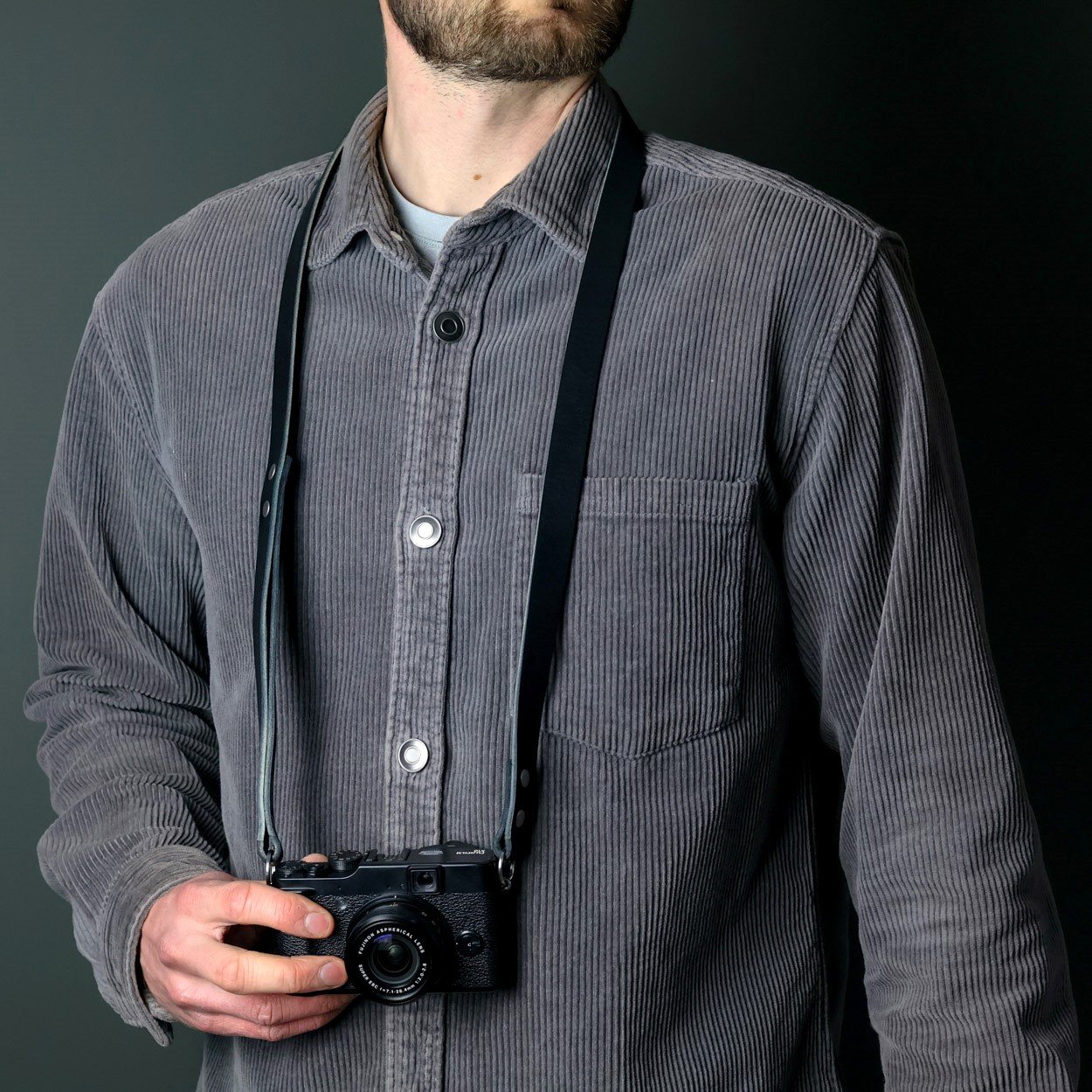 Black leather neck strap with Fujifilm camera strap