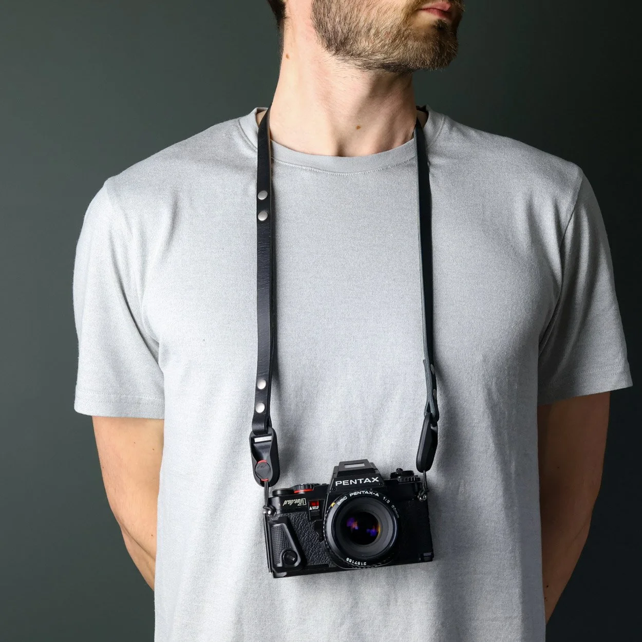 Peakdesign leather camera strap being worn on neck