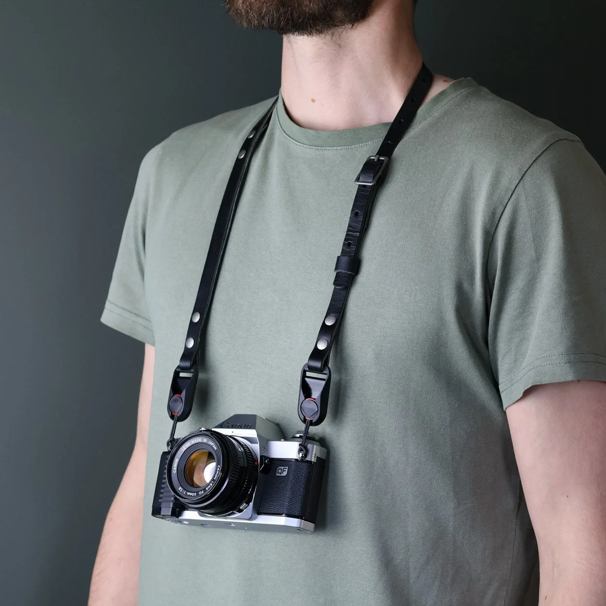 Summit qr camera strap with peak design quick release anchors being worn around the neck with a Canon camera