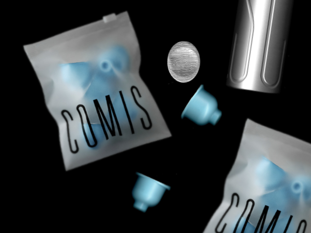 Cassette tapes, two IV bags labeled 'COMIS', two medical needles, and a metal container, all floating against a black background.
