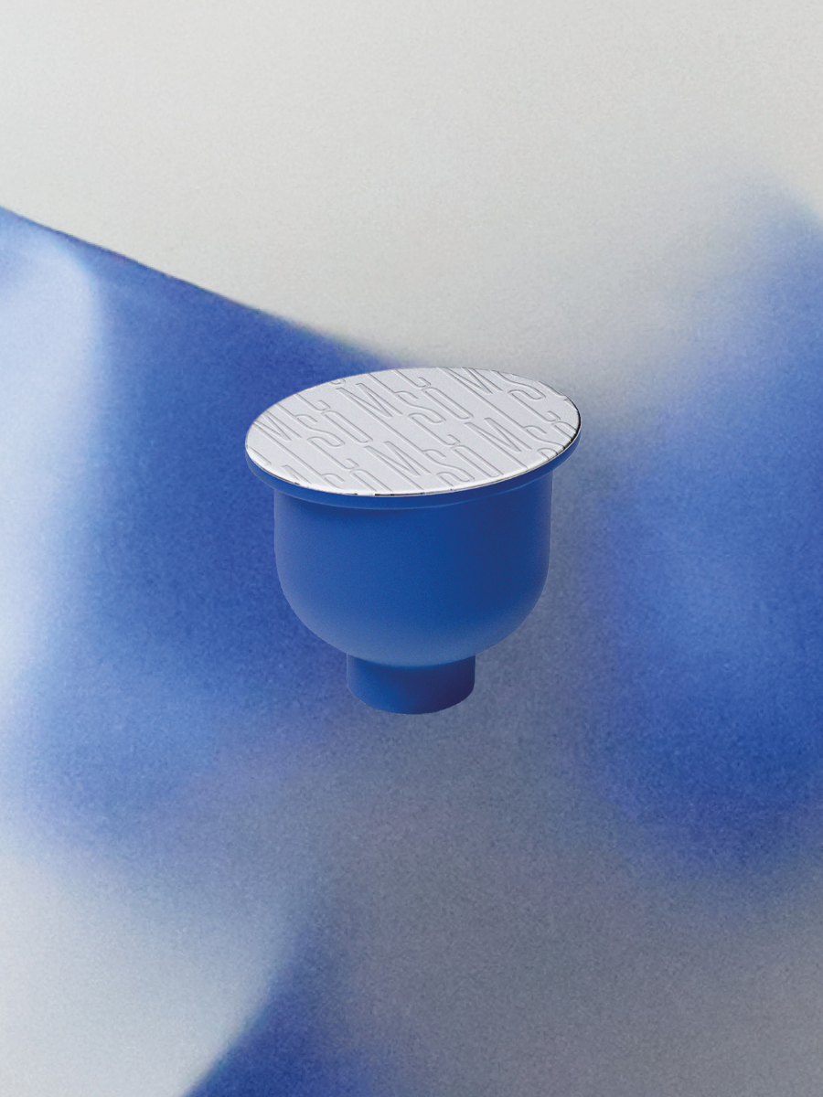 A blue object with a flat white top featuring embossed text, placed on a blue and white surface with shadows.
