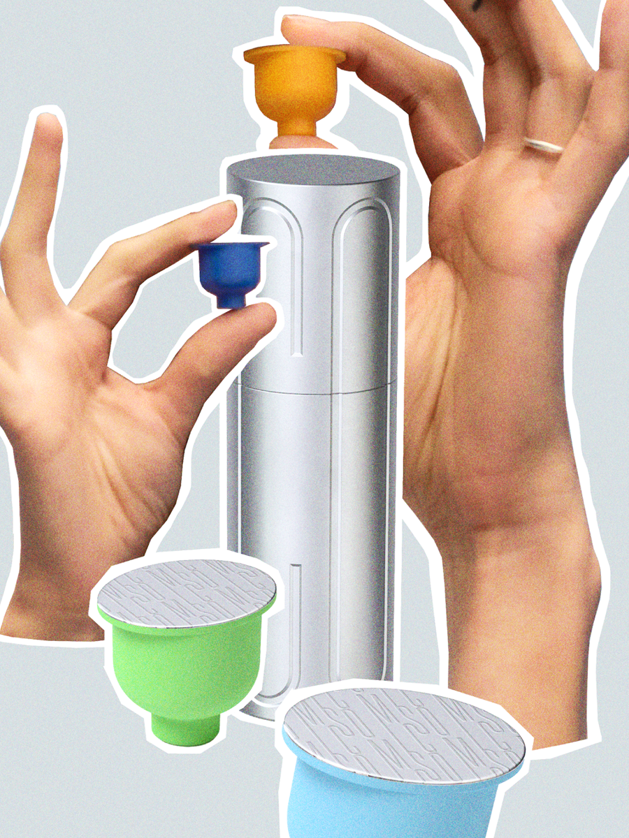 Two hands holding colorful capsules near a cylindrical capsule filling machine with three open capsules in different colors.