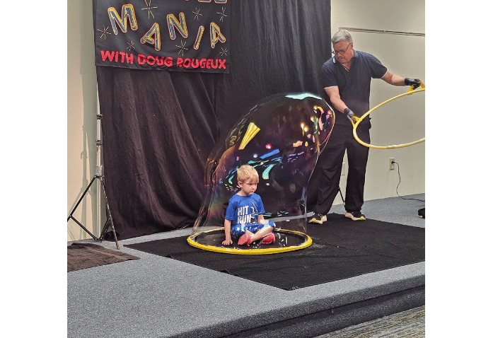 Young boy placed in bubble in magic show