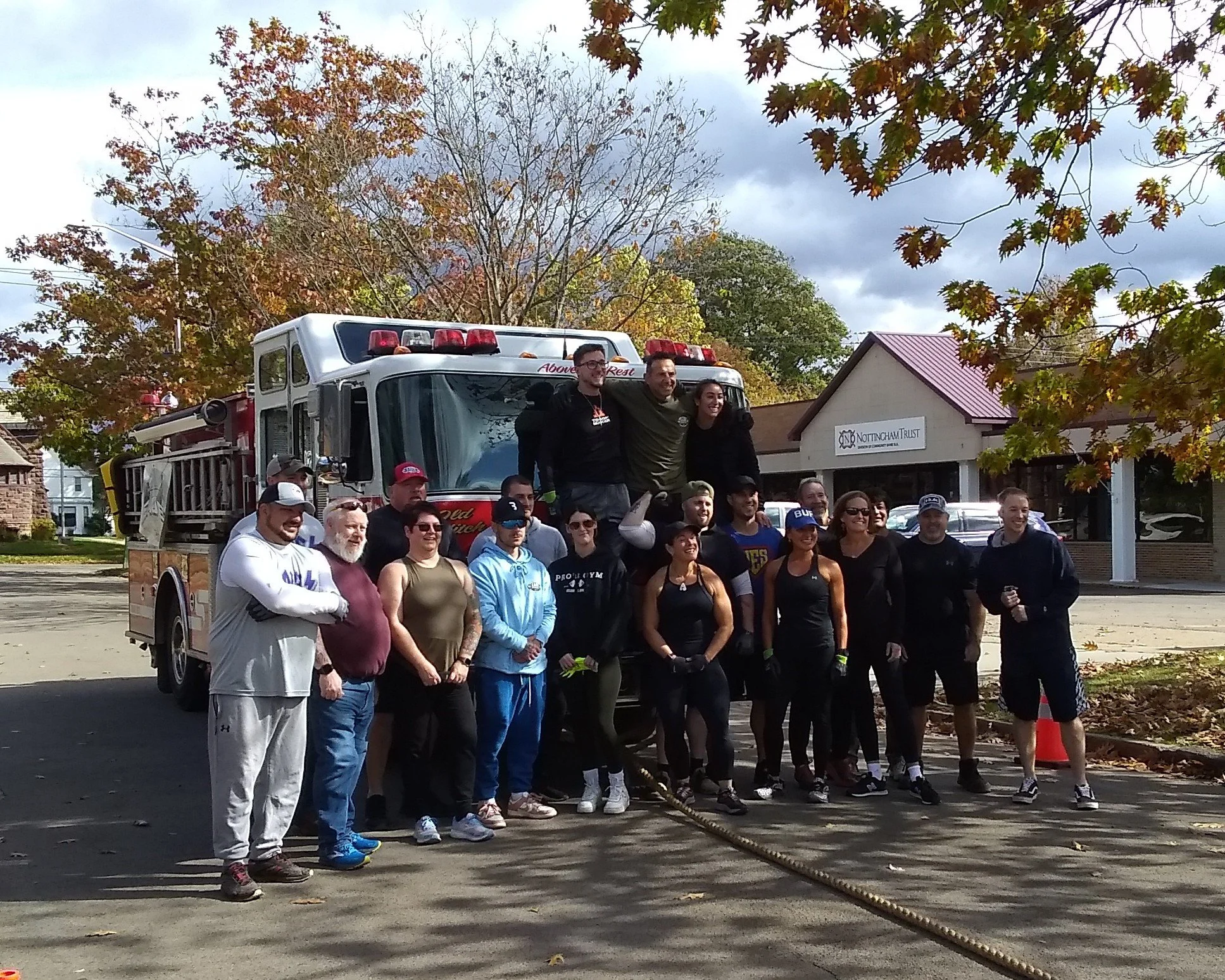 Men and women stand in front of a fire truck