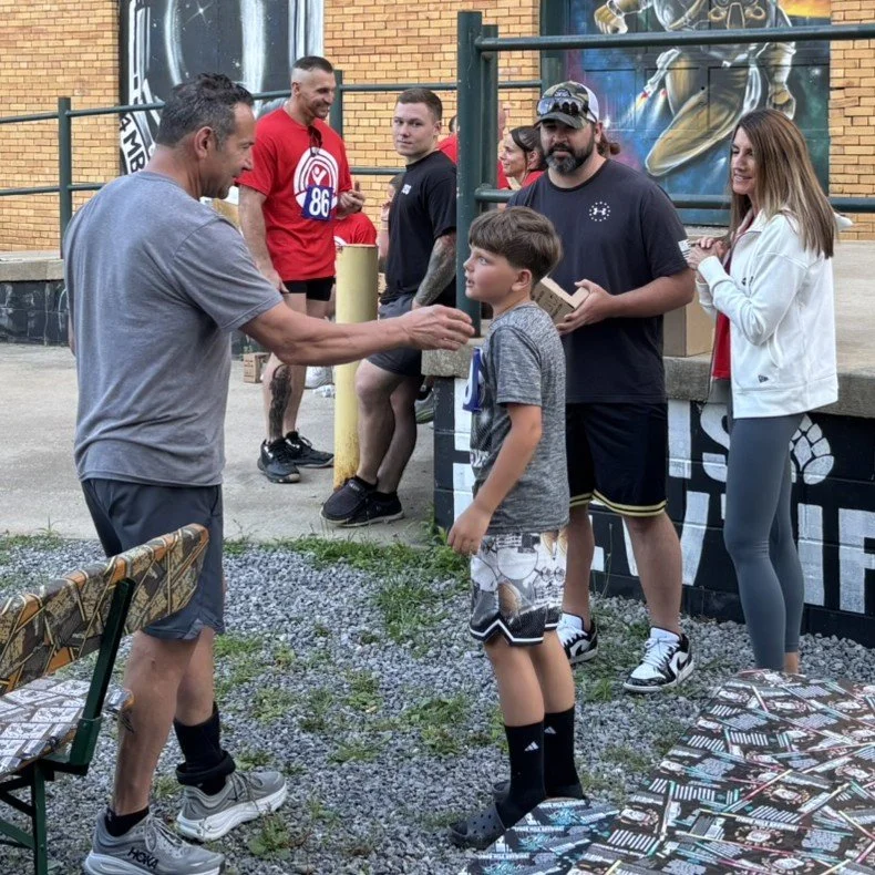 A man congratulates a young competitor after a race.