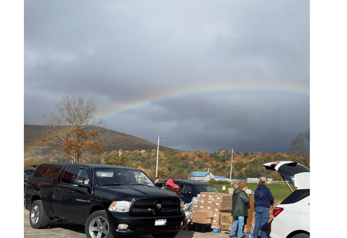 Volunteers distribute donated food from pallets