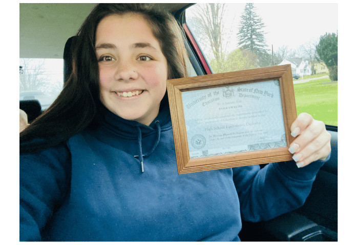 Woman holding GED certificate