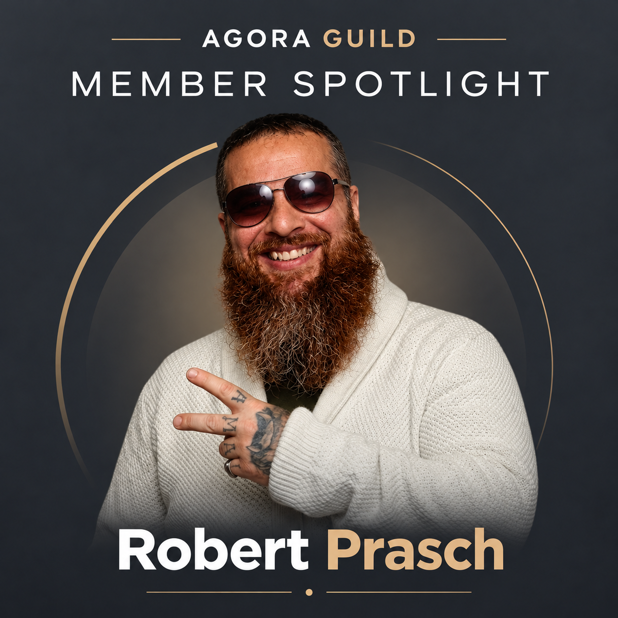 Robert Prasch featured in Agora Guild's Member Spotlight, smiling with a long beard, aviator sunglasses, and cream knit cardigan against a charcoal and gold branded background.