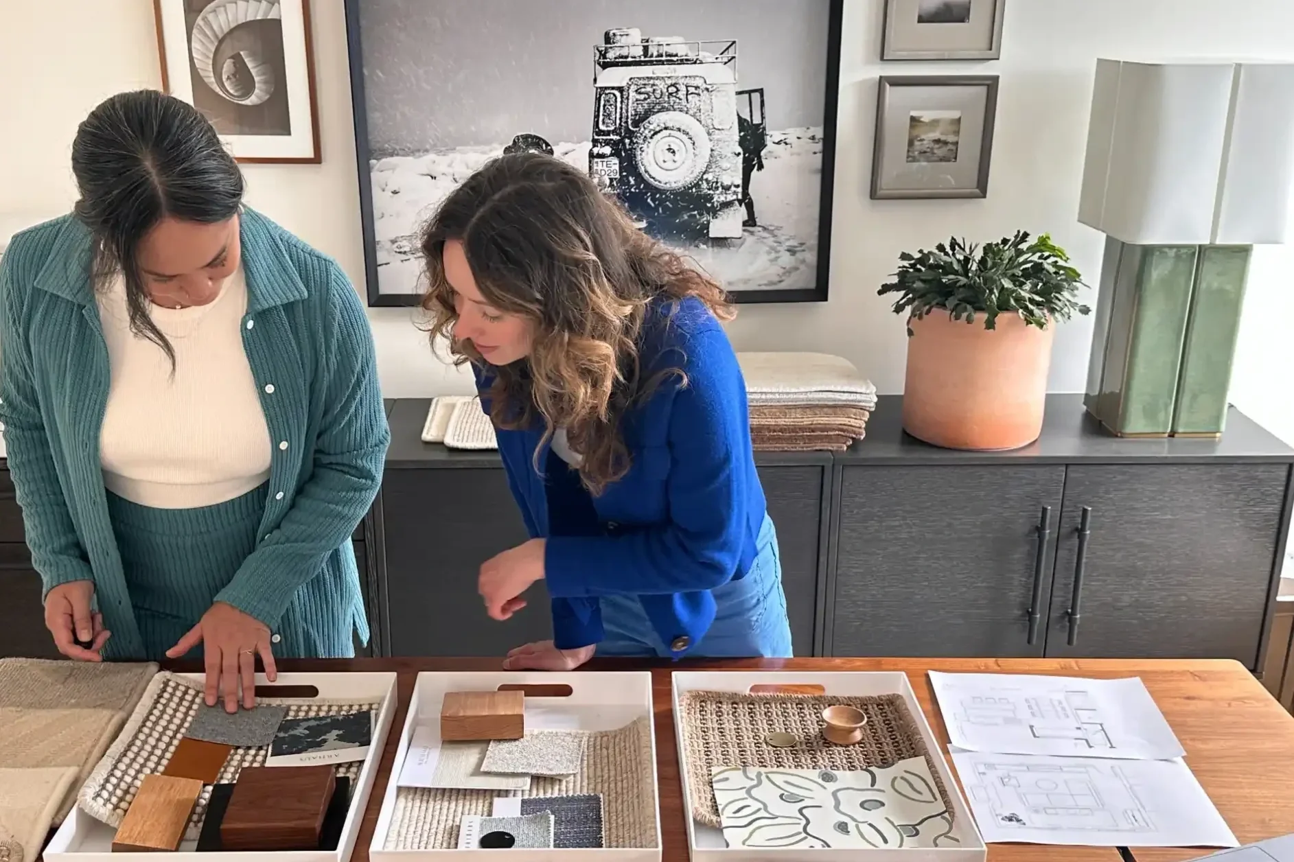 Veronica and Aggie of Studio VAE reviewing material samples and floor plans together at their San Francisco interior design studio.