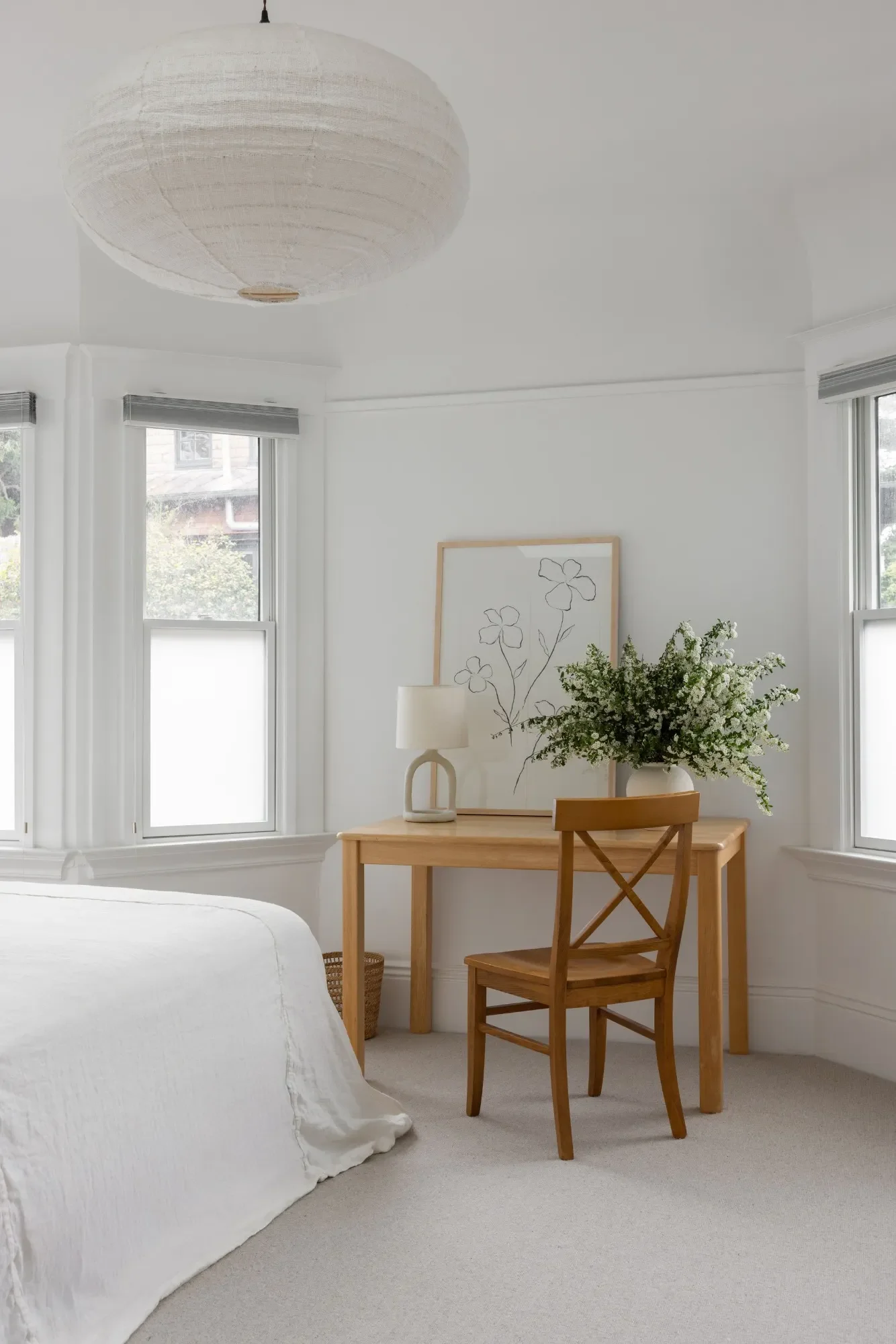 Parnassus Heights primary bedroom — oak desk workspace, bay window, and woven paper pendant by Studio VAE.