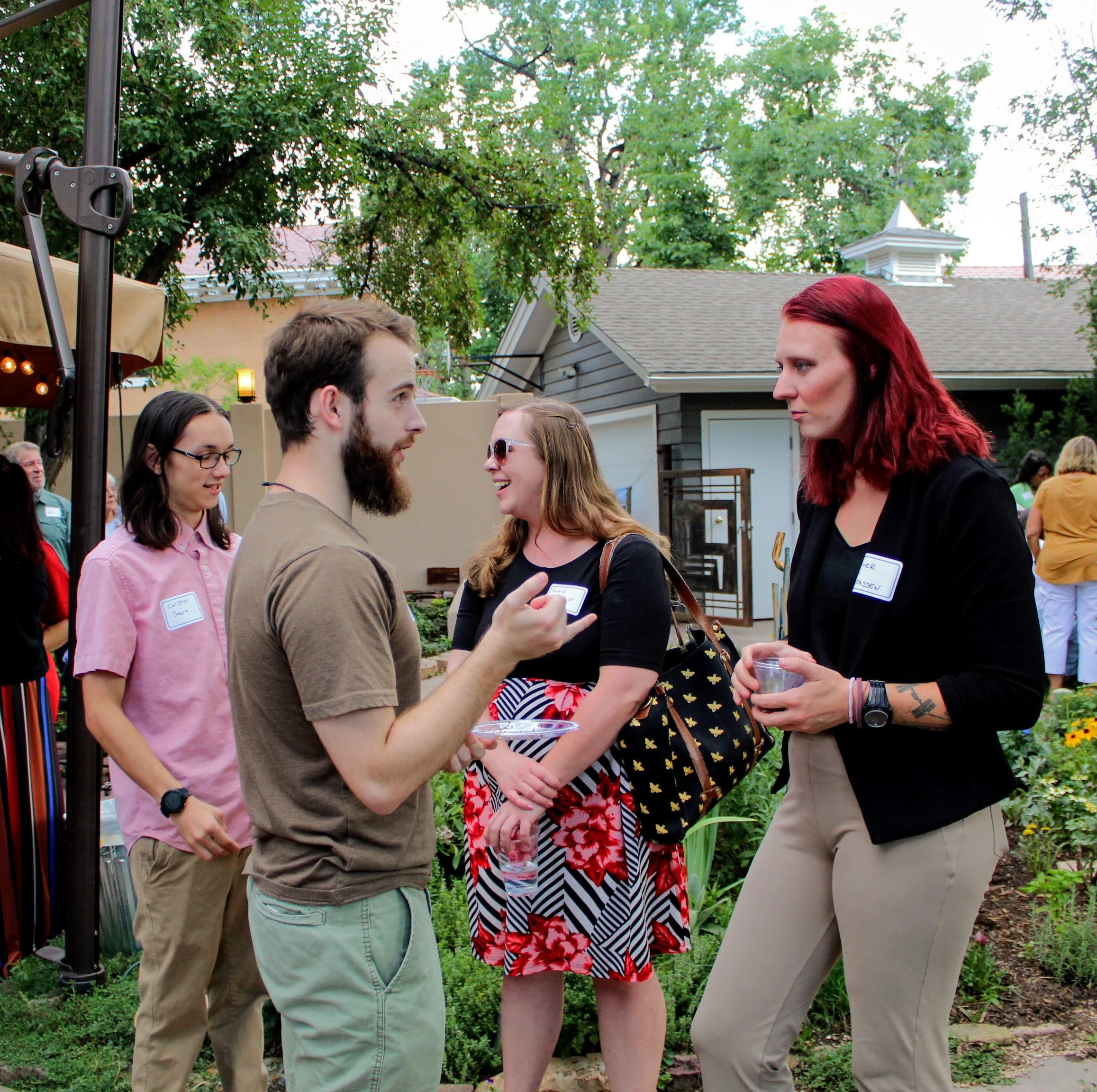 Group of people socializing outdoors at a garden event