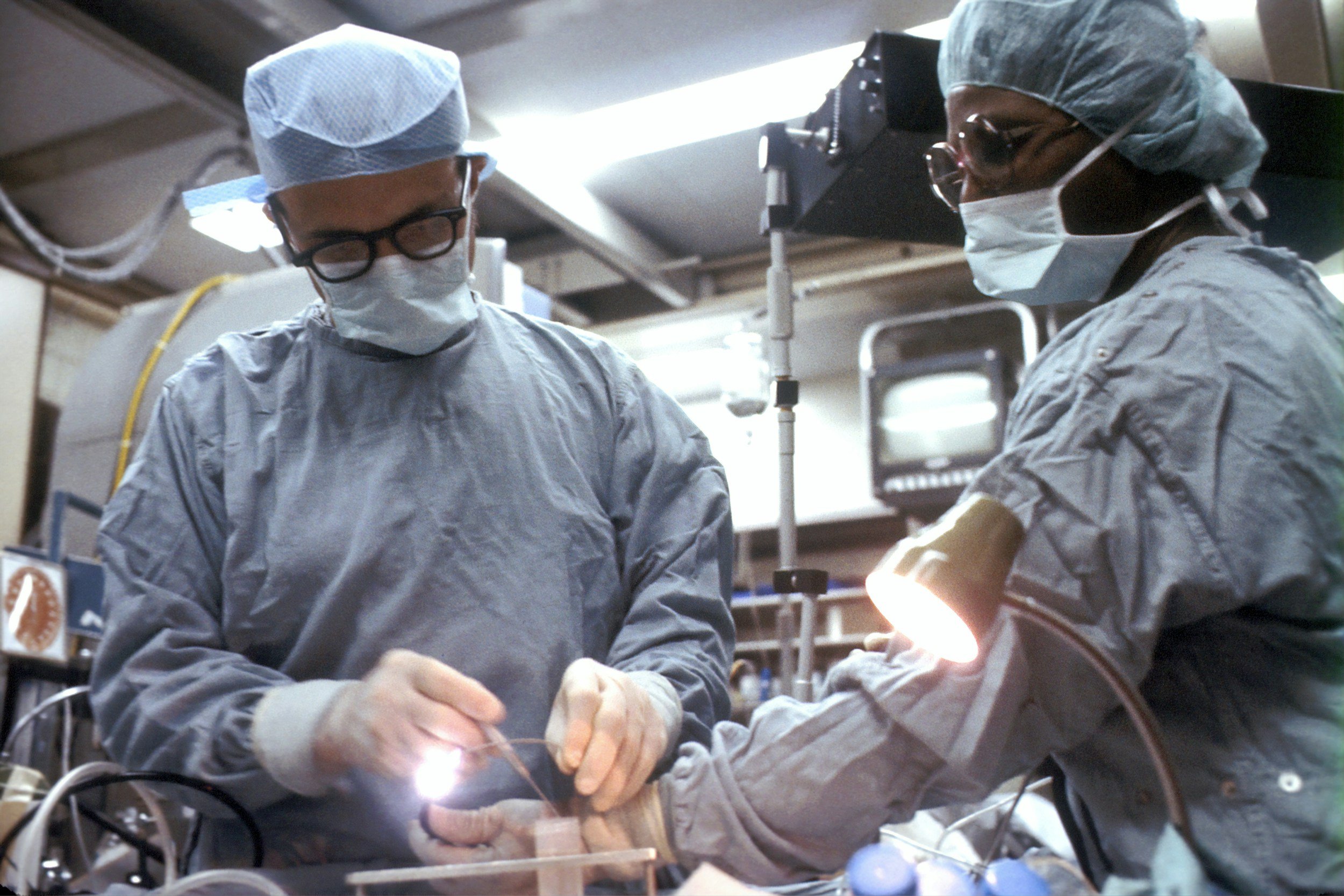Surgeons in the surgery room, working on a patient.