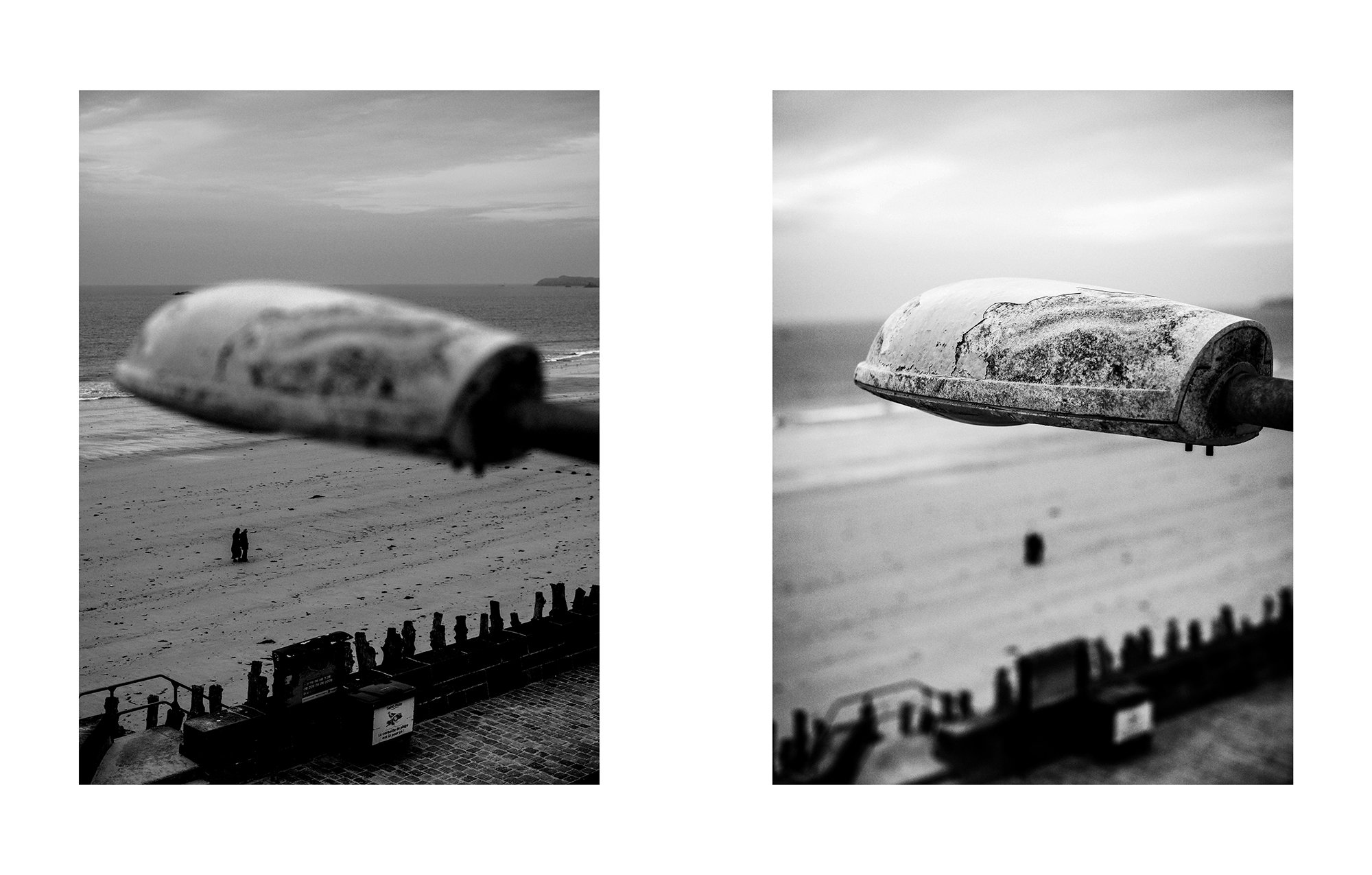 Two black-and-white photographs of the beach with a weathered streetlamp in the foreground. The left photo shows the streetlamp blurred with a view of the sandy beach, ocean, and sky in the background. The right photo captures a closer, sharper view 