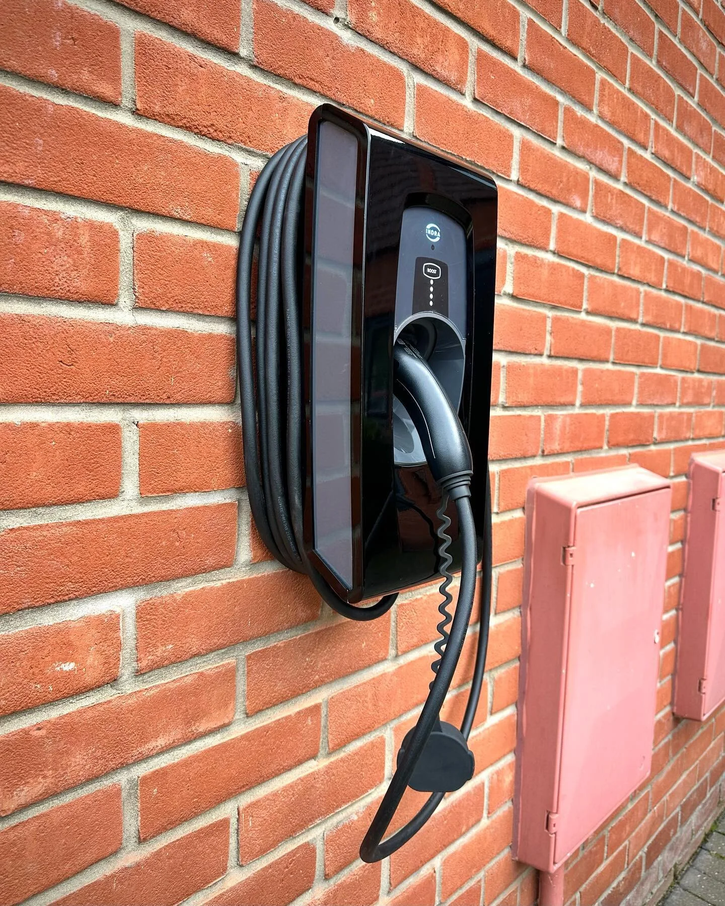 Does your smarthome or audiovisual contractor have qualified electricians on staff? @butler.harwell is proud to say we do! Here’s a bespoke-painted @indra.ev charger - retrospectively installed with no cables on show - other than the charging o