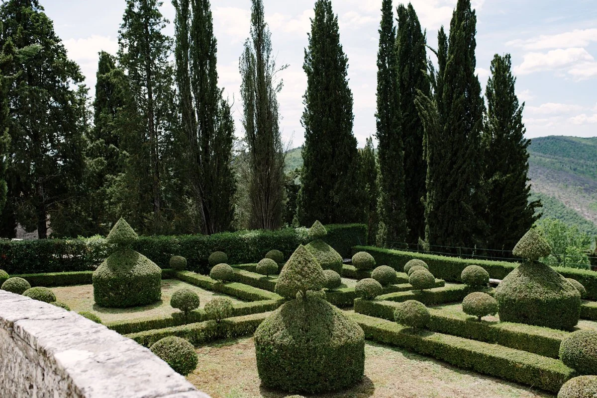 Italian garden at Borgo Pietrafitta with classic landscaping and views of the Tuscan countryside.
