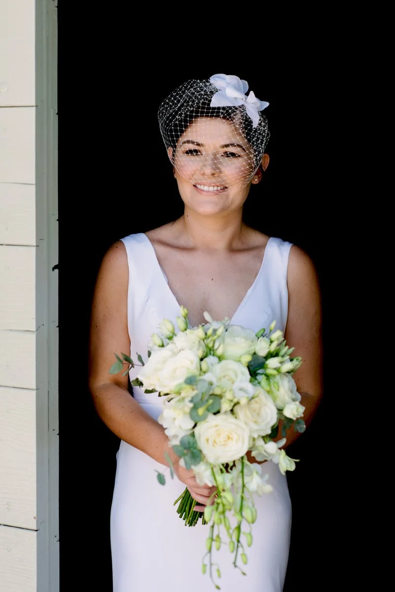 Bride smiling while holding her bouquet at Conti di San Bonifacio wedding venue.
