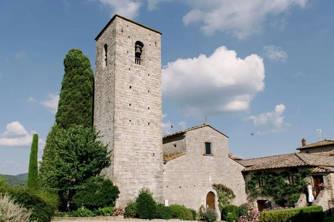 Castello di Spaltenna wedding venue in Tuscany, showing the historic stone castle surrounded by olive groves and rolling Chianti countryside near Gaiole in Chianti.