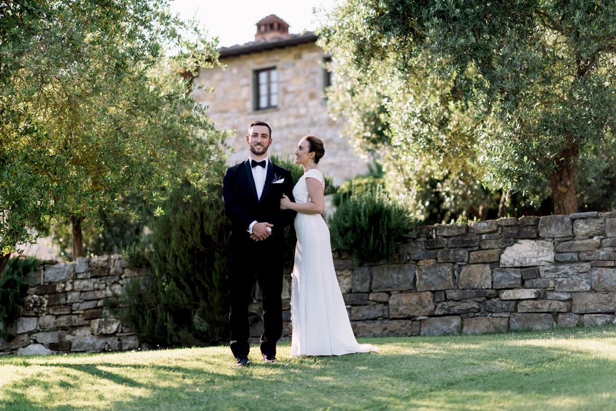 Couple standing in the garden at Castello di Spaltenna where the wedding ceremony took place.