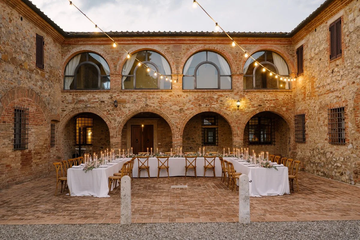 Wedding dinner table decoration with candles and floral details prepared for reception at Villa Boscarello.