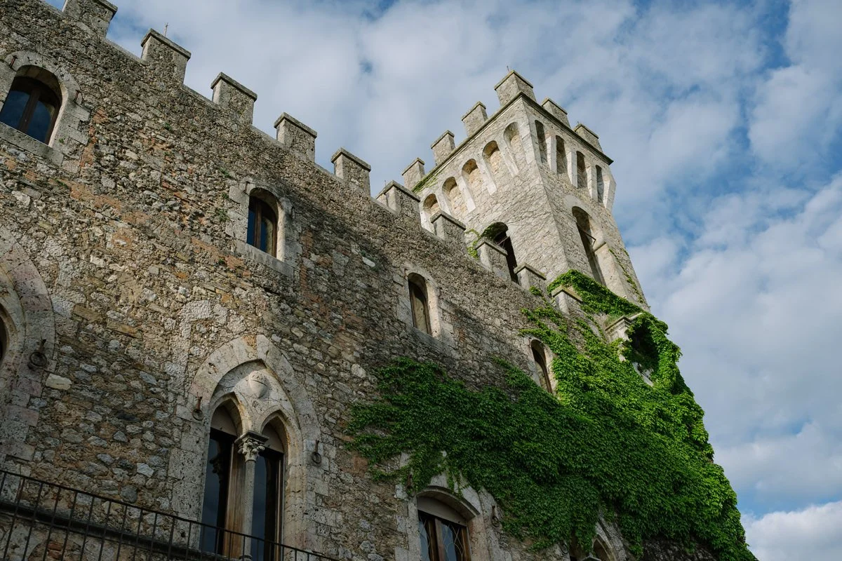 The historic tower of Castello di Celsa rising against the sky, a landmark wedding venue in Tuscany.