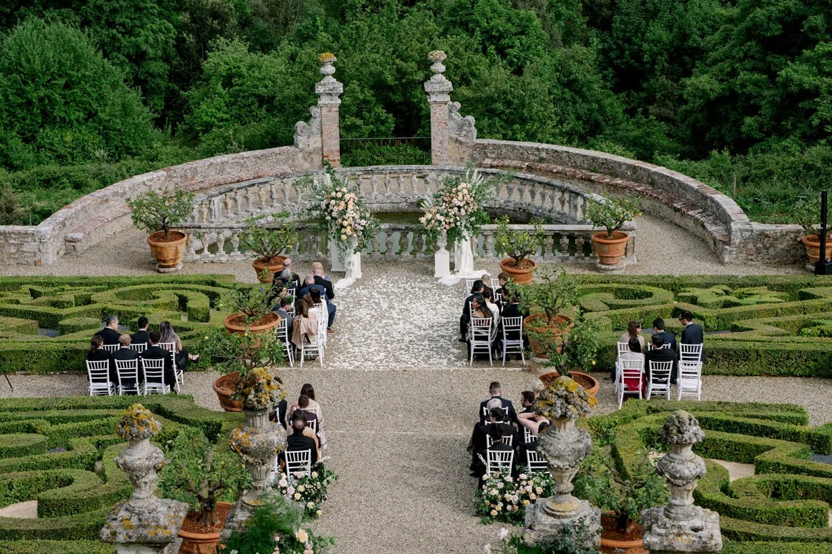 Overhead view of a wedding ceremony at Castello di Celsa with guests seated in the Italian garden.