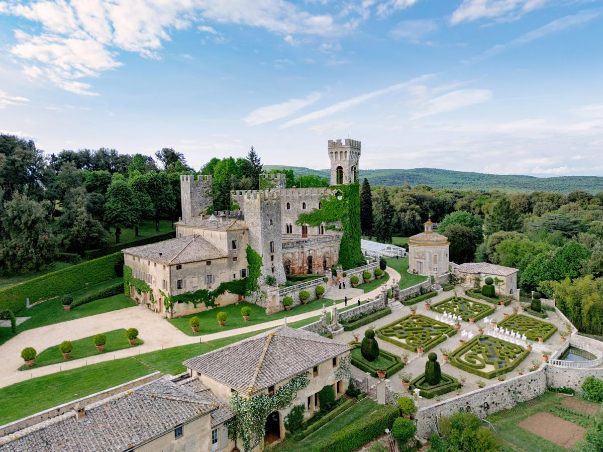 Drone view of Castello di Celsa wedding venue showing the castle, gardens, and surrounding Tuscan landscape.
