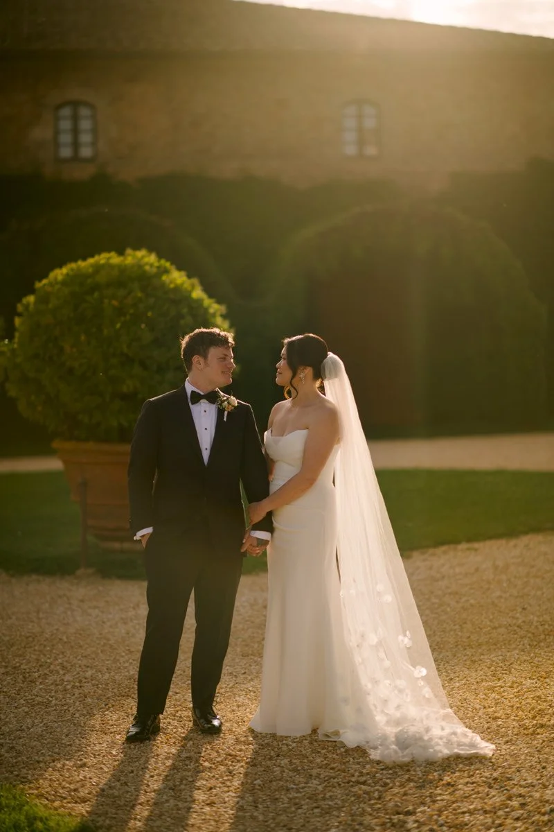 Couple sharing a quiet moment at golden hour with Castello di Celsa in the background during their Tuscany wedding.