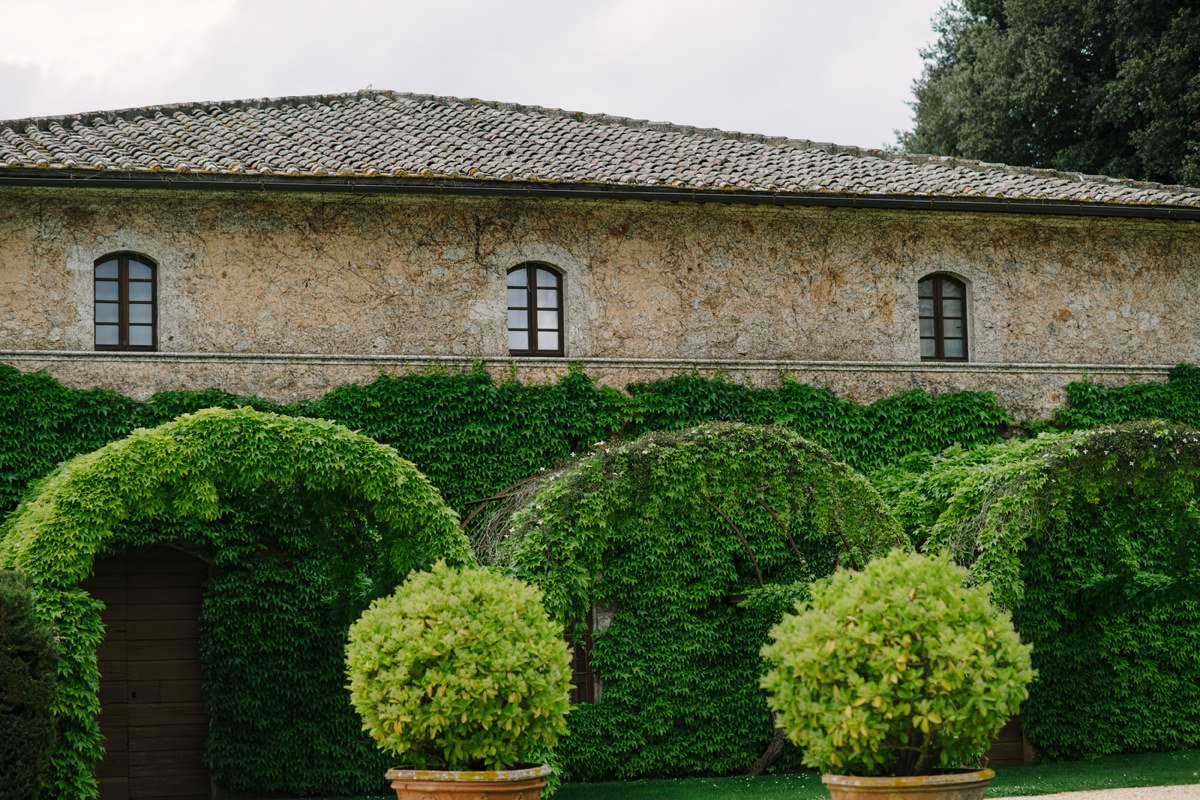 Stone arches and manicured greenery at Castello di Celsa, part of the historic wedding venue grounds in Tuscany.