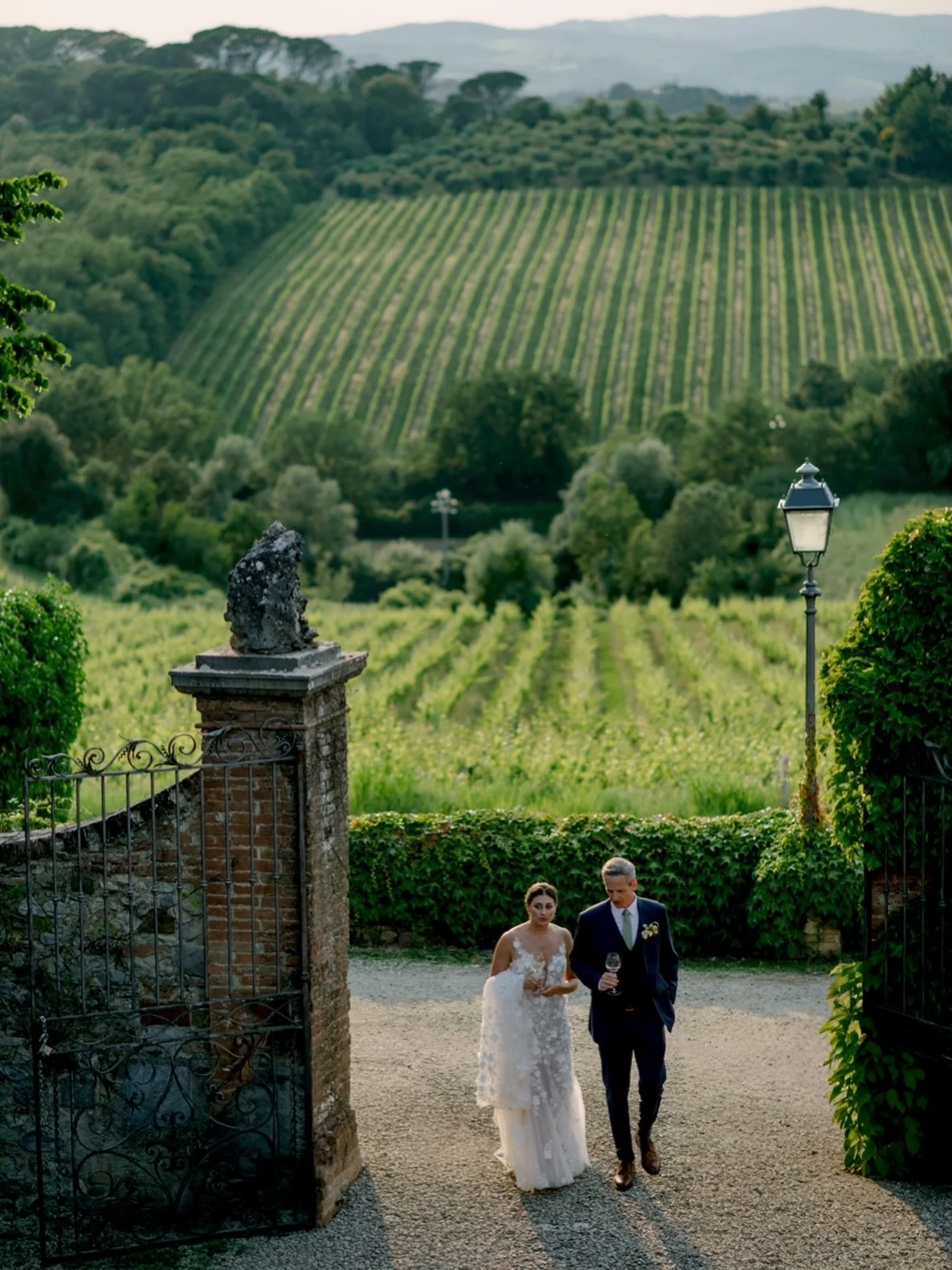How stunning is the view from Castello di Bossi ✨

Walking into the courtyard with the Chianti vineyards stretching out behind them, this moment felt effortlessly timeless.
This is wedding photography in Tuscany where the setting does half the storyt