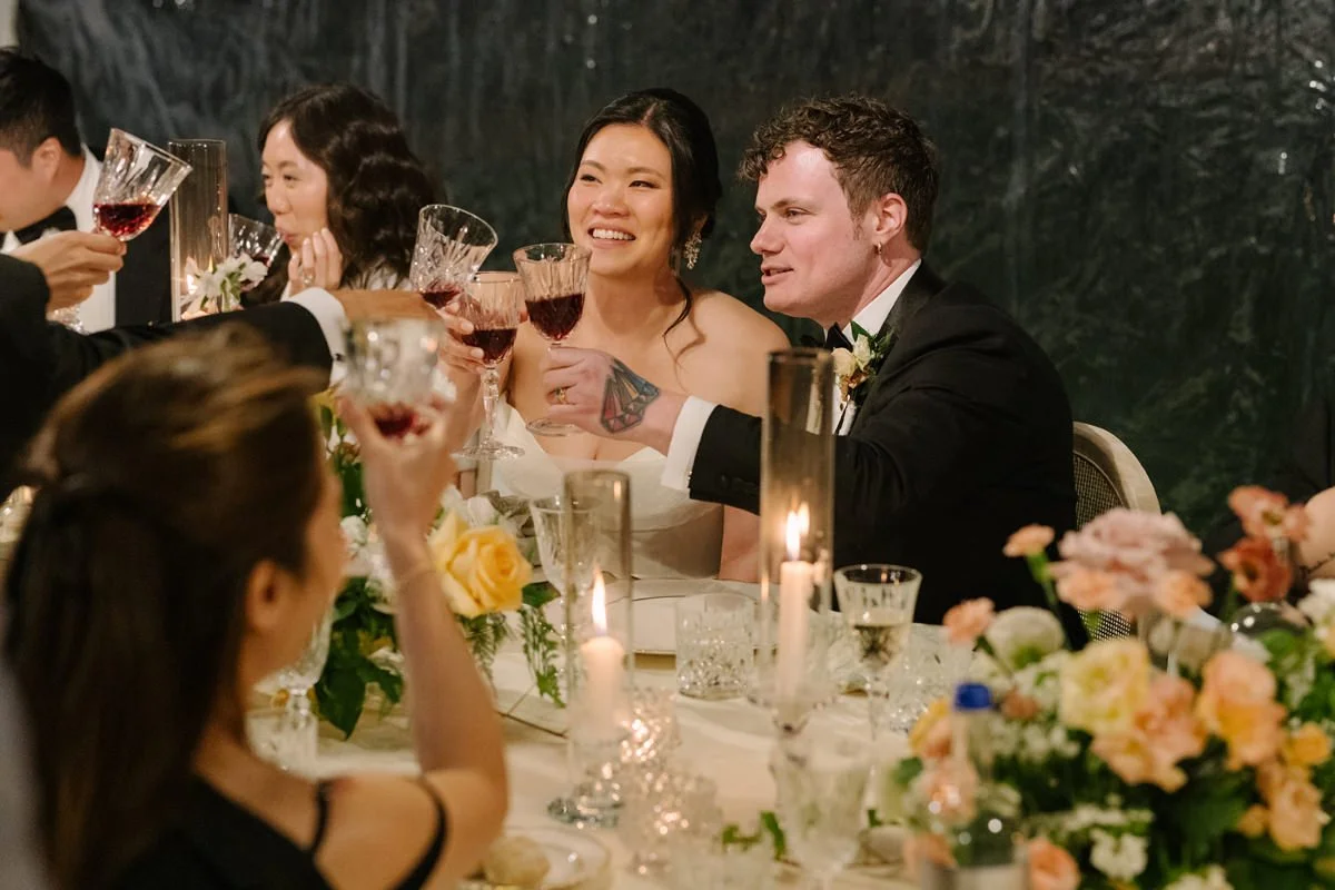 Bridal couple cheering at the dinner