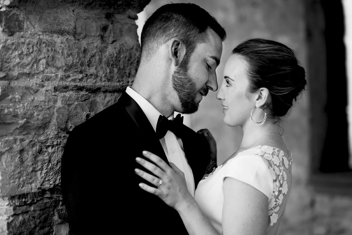 Black and white close-up portrait of a wedding couple looking at each other at Castello di Spaltenna.