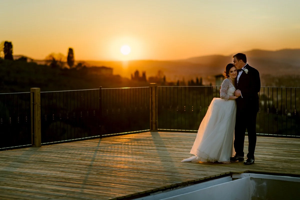 Bride and groom standing close together near the pool at sunset at Villa Hotel Tolomei wedding venue.