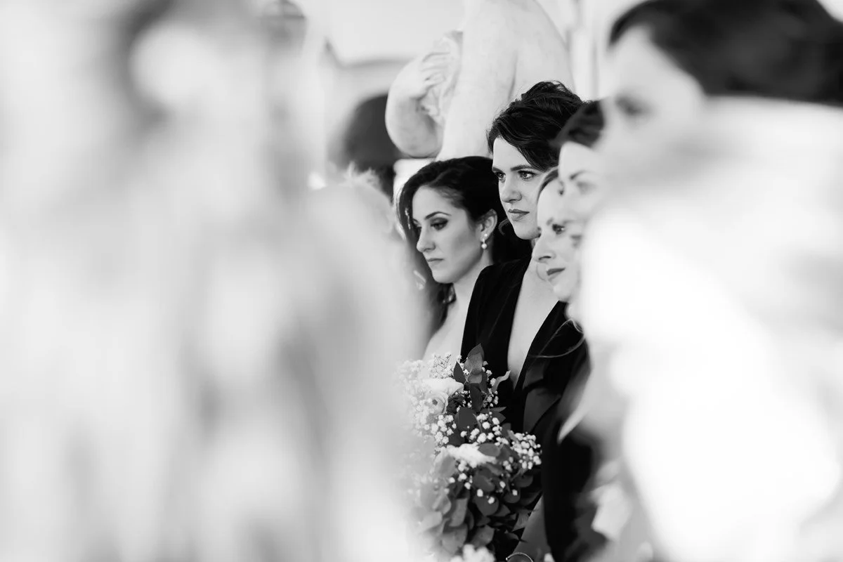 Black and white fine-art portrait of a bridesmaid during the ceremony at Villa Hotel Tolomei terrace.