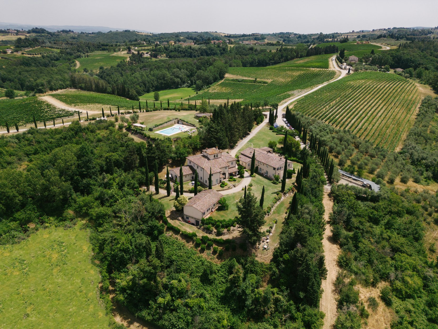 Aerial drone view of Borgo della Meliana wedding venue surrounded by vineyards and Tuscan countryside, FunkyBird Photography