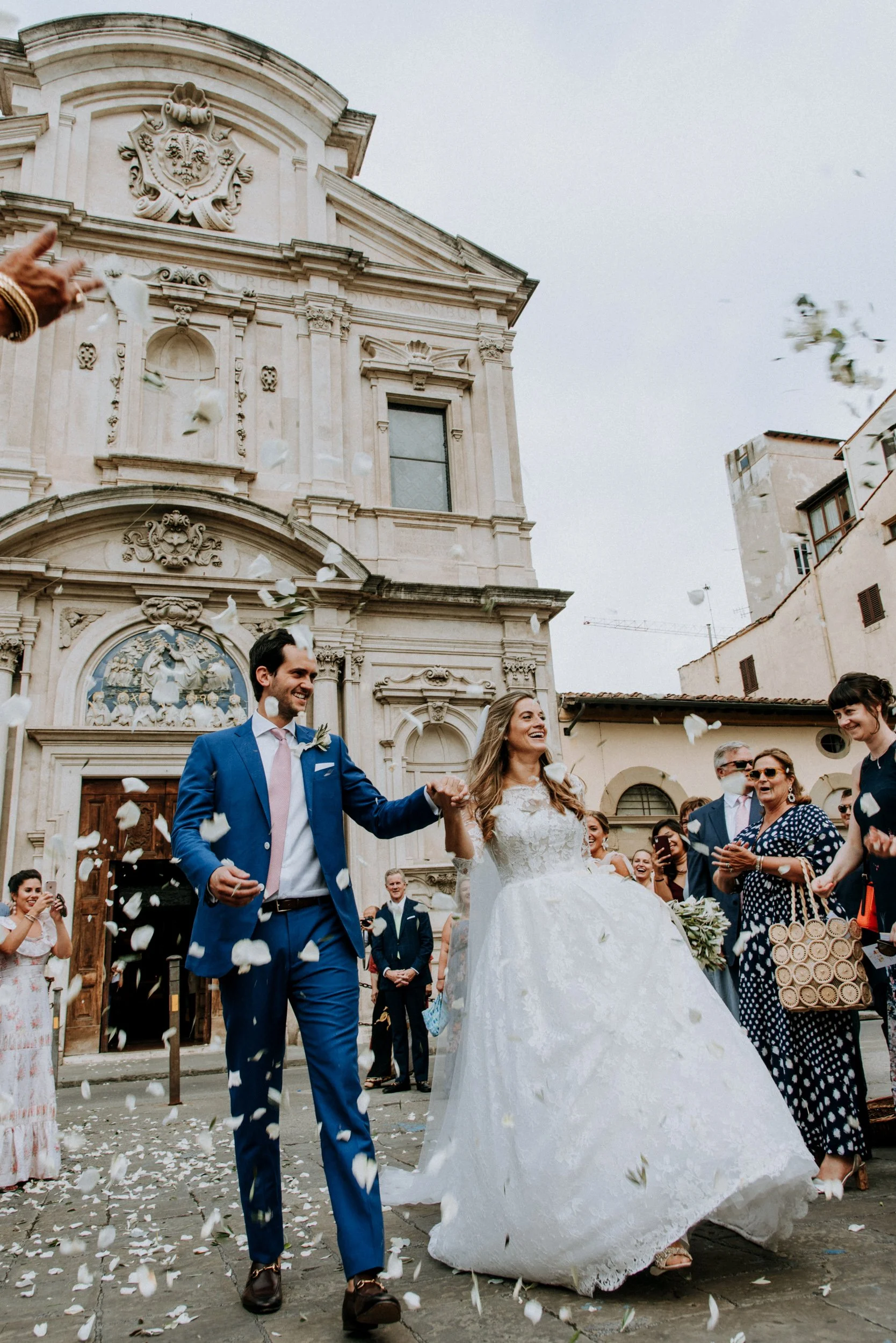 Confetti falling as the couple leave Chiesa di Ognissanti in Florence after their church ceremony