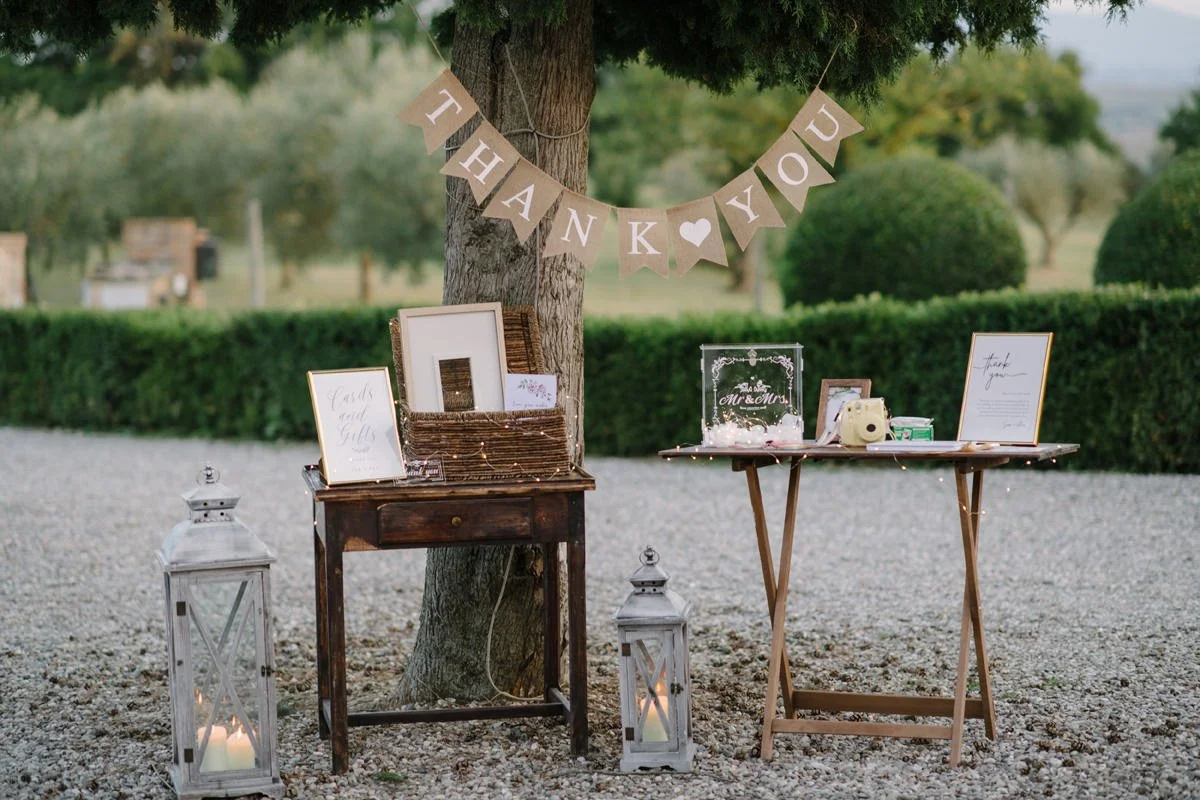 Wedding table details at Villa Boscarello featuring a vintage camera and guest book arranged for guests.