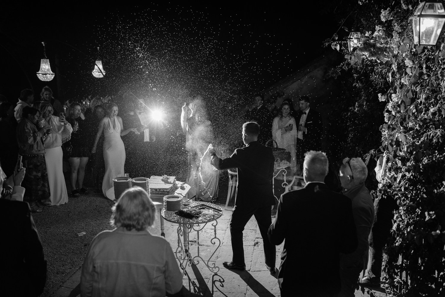 Black and white wedding party moment with prosecco spray at Villa di Ulignano, October Tuscany wedding by FunkyBird Photography
