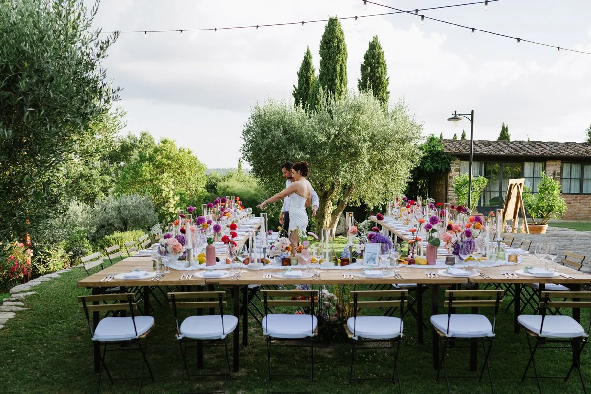 Bride and groom looking wedding dinner table at Casa Cornacchi