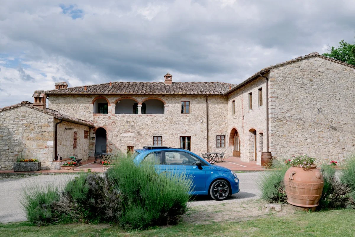 Fiat Cinquecento parked near the ceremony area at Castello di Meleto, adding a classic Italian touch to the Tuscany wedding setting.
