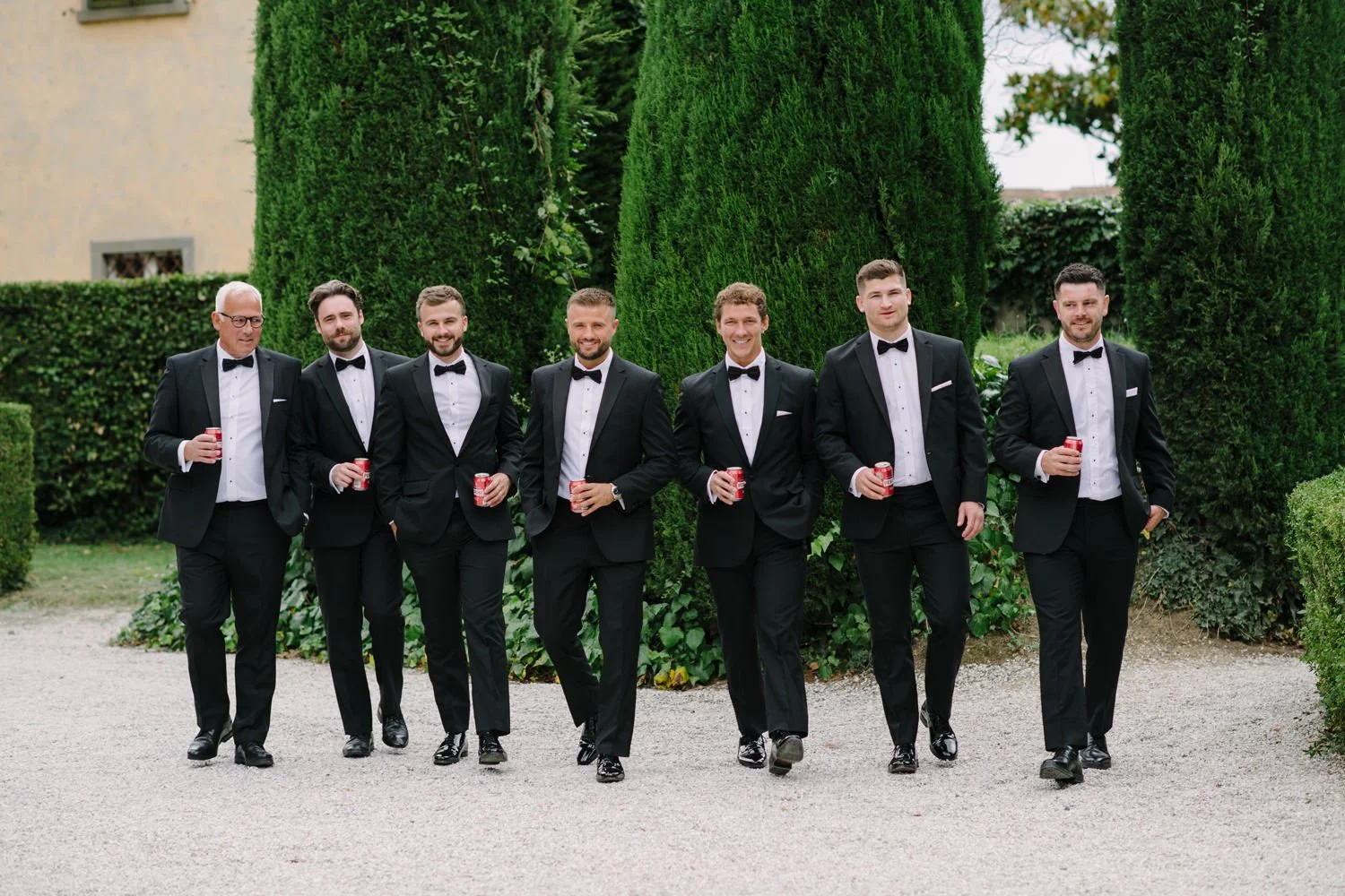 Groomsmen walking together in the gardens of Villa di Ulignano before the ceremony, by FunkyBird