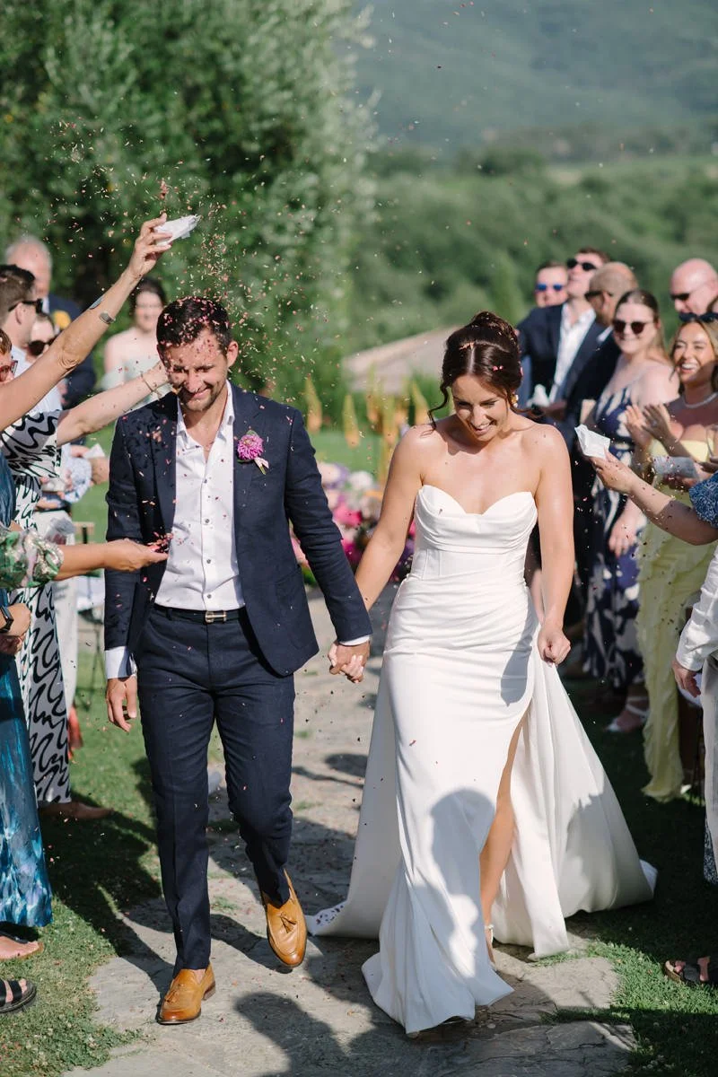 Bridal couple walking after their Tuscany wedding ceremony