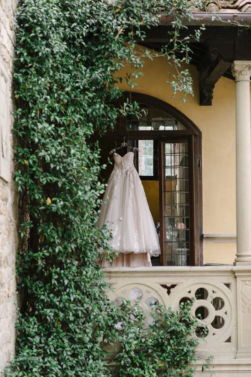 Wedding dress hanging on the terrace of Castello Il Palagio