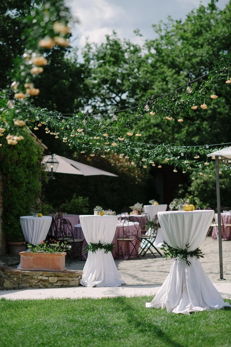 Tall tables arranged for the welcome dinner party at Le Filigare wedding venue in Tuscany.