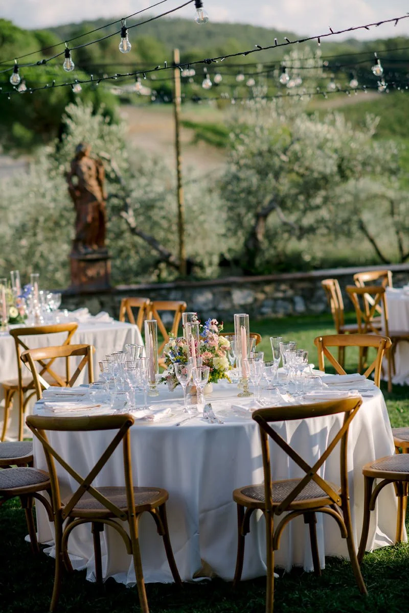 Second view of round wedding dinner tables on the terrace at Le Filigare wedding venue in Tuscany.
