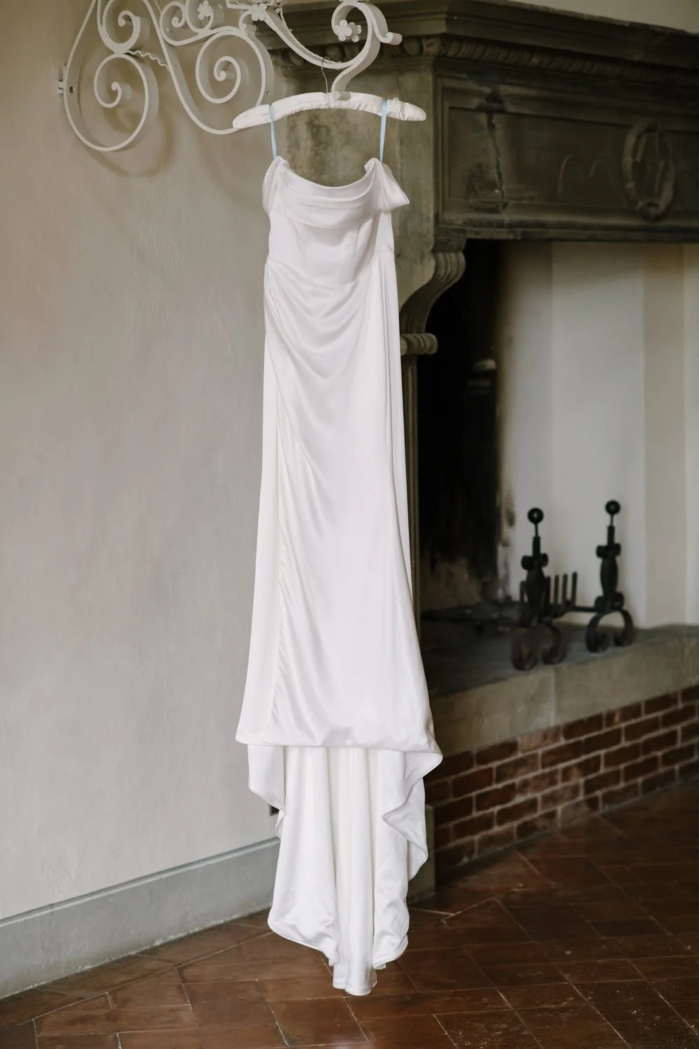 Wedding dress hanging in natural light at Villa di Ulignano, October Tuscany wedding by FunkyBird