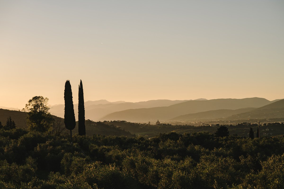 Sunset view from the terrace at Villa Medicea di Lilliano overlooking the Tuscan hills with Florence in the distance