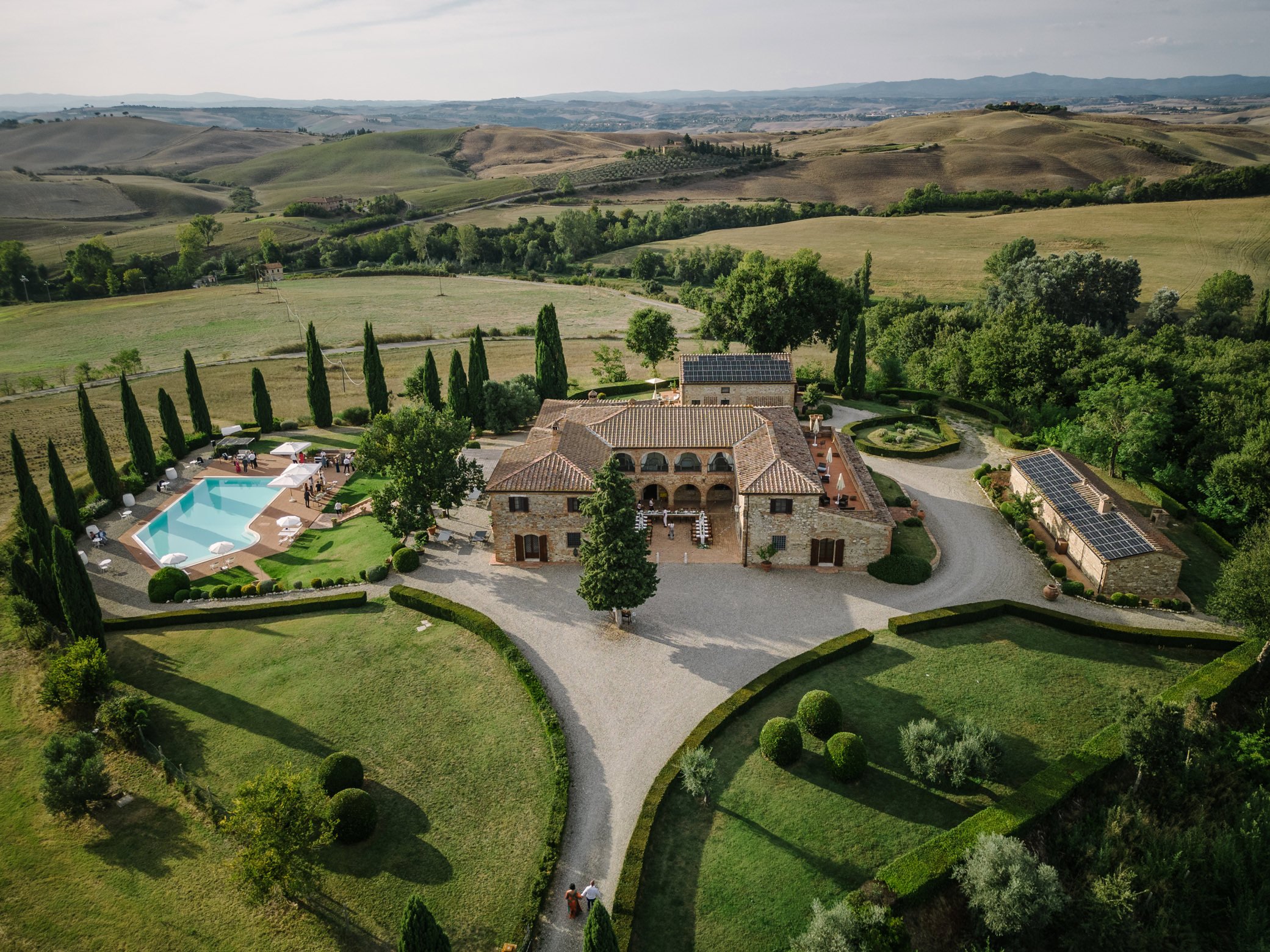 Drone view of Villa Boscarello wedding venue in Tuscany showing the main villa, swimming pool, gardens, and surrounding countryside layout.