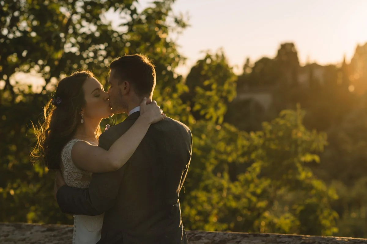 Wedding couple kissing during sunset at Villa Medicea di Lilliano