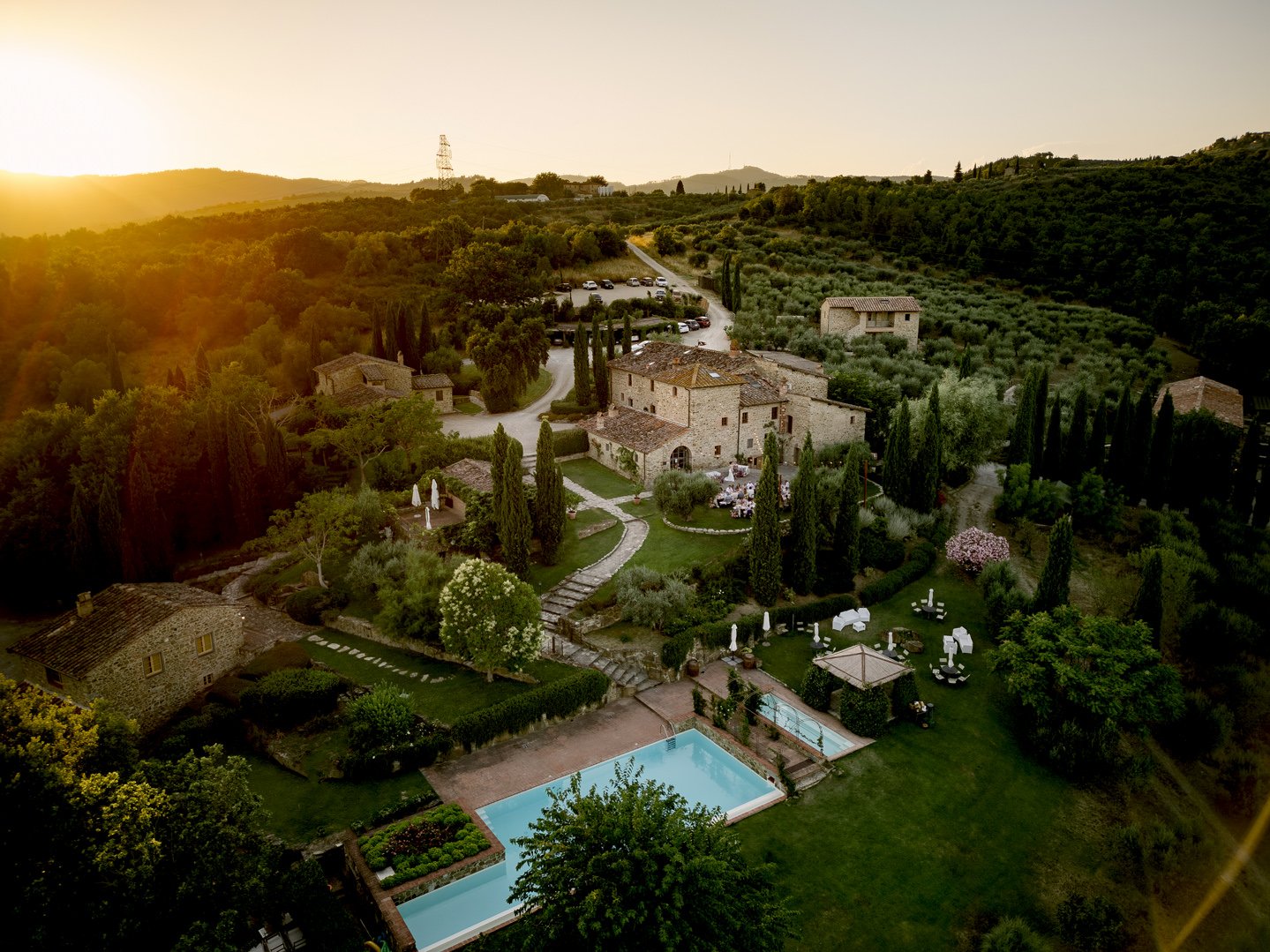 Casa Cornacchi villa in the Tuscan countryside with stone terraces and warm golden landscape.