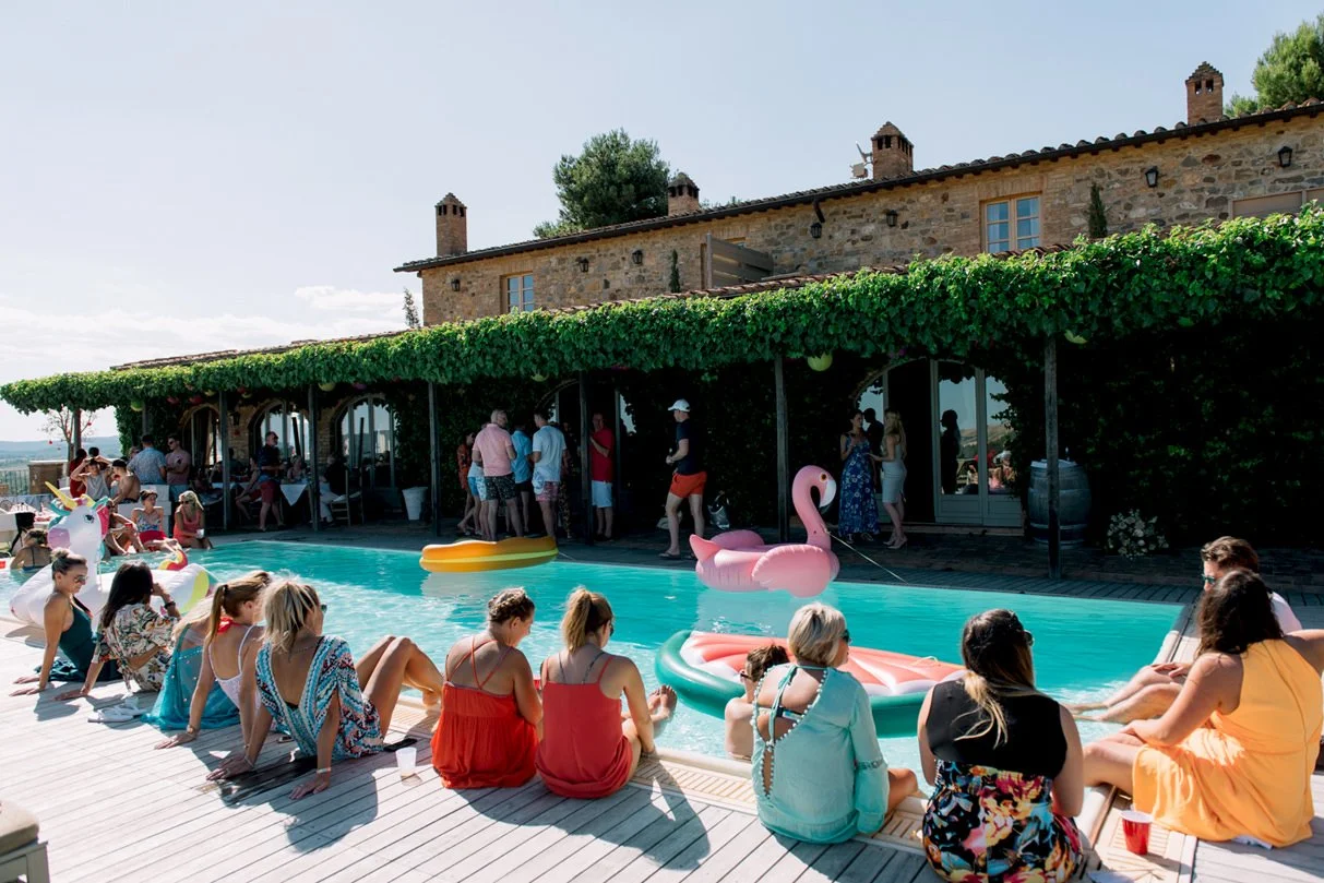 Wedding guests relaxing by the pool during a third-day barbecue party at Conti di San Bonifacio.